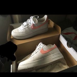 Airforce 1’s with a pink nike stripe